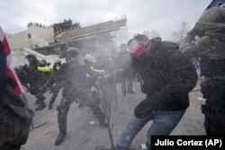 Supporters of Republican President Donald Trump try to break through a police barrier on January 6, 2021 at the U.S. Capitol, where thousands of people gathered to contest Democratic presidential candidate Joe Biden's win of the 2020 U.S. presidential election.