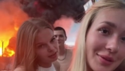 Sochi. Blogger Karina Oshchurkova shoots a video against the backdrop of a burning oil depot